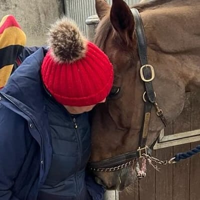 kat williams-jones affectionately interacting with horse.